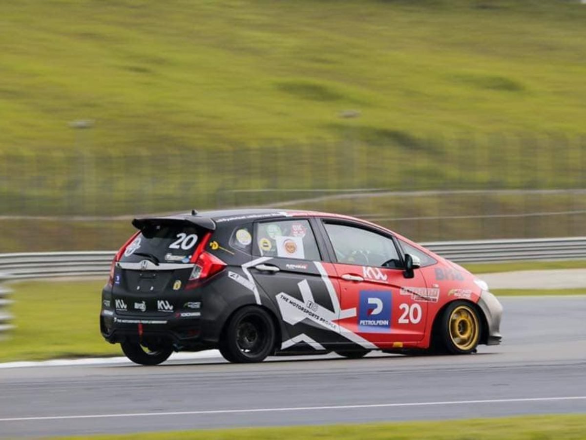 Rear three-quarter view of the number 20 race car on track